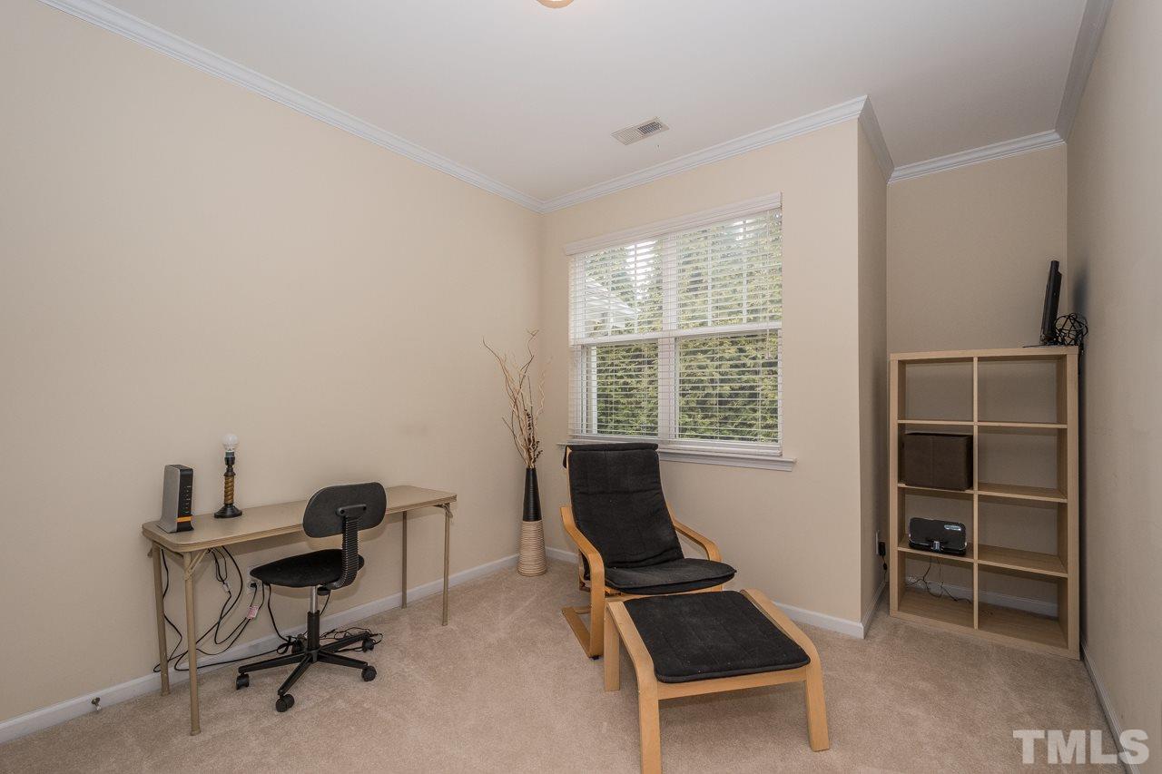 4924 Amber Clay Lane Raleigh, NC 27612 - Photo 21 of 24 a view of a workspace with furniture and a window