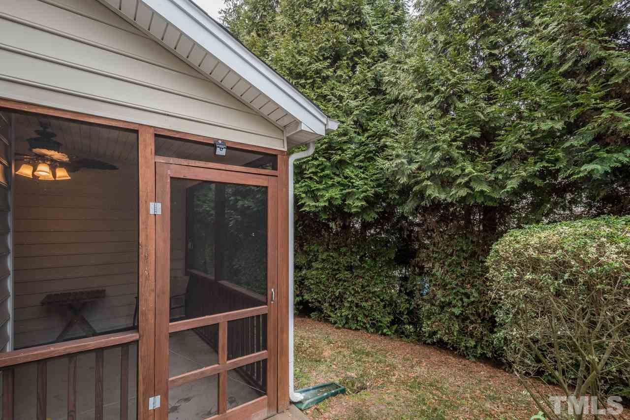 4924 Amber Clay Lane Raleigh, NC 27612 - Photo 24 of 24 a view of backyard with potted plants and floor to ceiling window