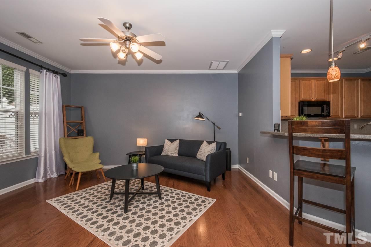 4924 Amber Clay Lane Raleigh, NC 27612 - Photo 6 of 24 a living room with furniture and a chandelier