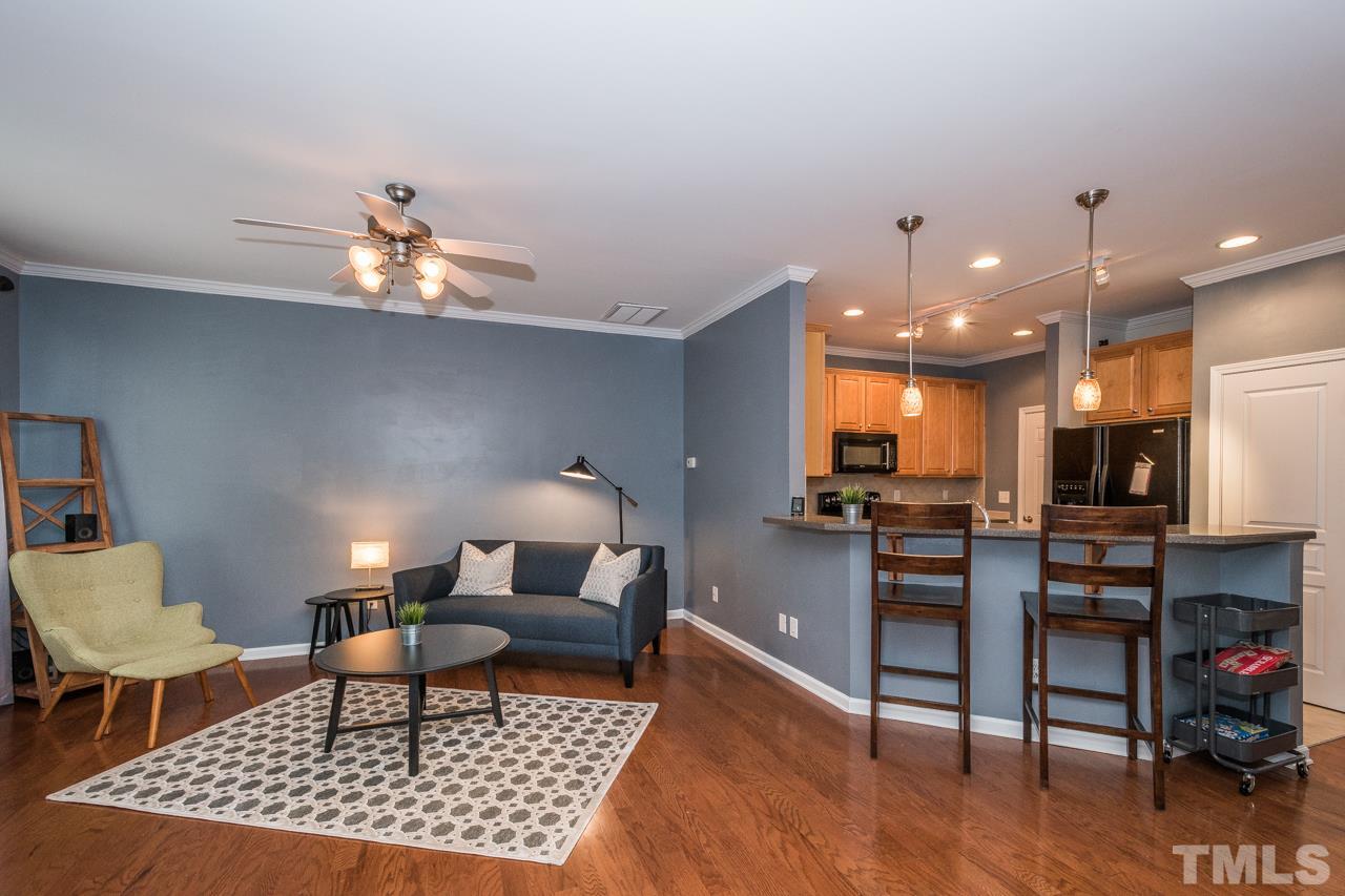 4924 Amber Clay Lane Raleigh, NC 27612 - Photo 7 of 24 a living room with furniture and a dining table with wooden floor