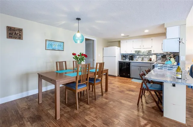 a living room with furniture a flat screen tv and floor to ceiling window