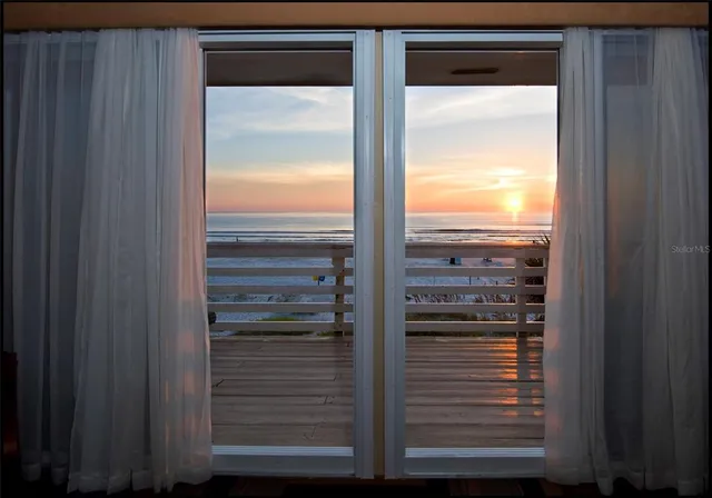a view of a chairs with table in front of a building
