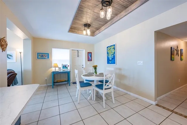 a spacious bedroom with a bed and a chandelier