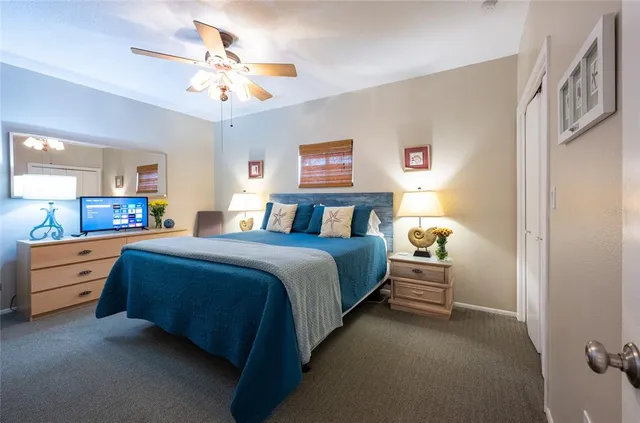 a spacious bedroom with two beds and a chandelier