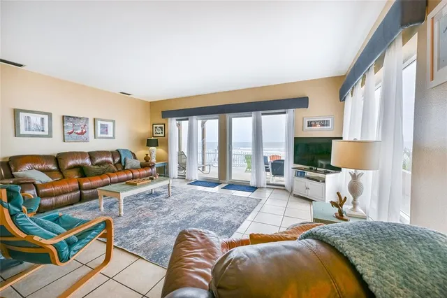 a view of a dining room with furniture and a window