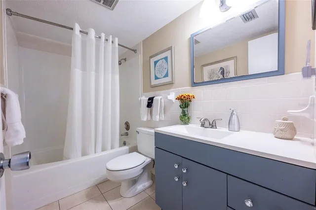 a living room with furniture a flat screen tv and a large window