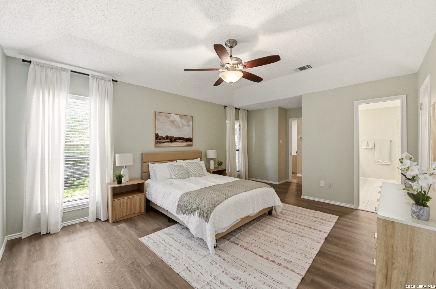 3820 Pheasant Schertz, TX 78108 - Photo 13 of 20 a bedroom with a large bed and a chandelier