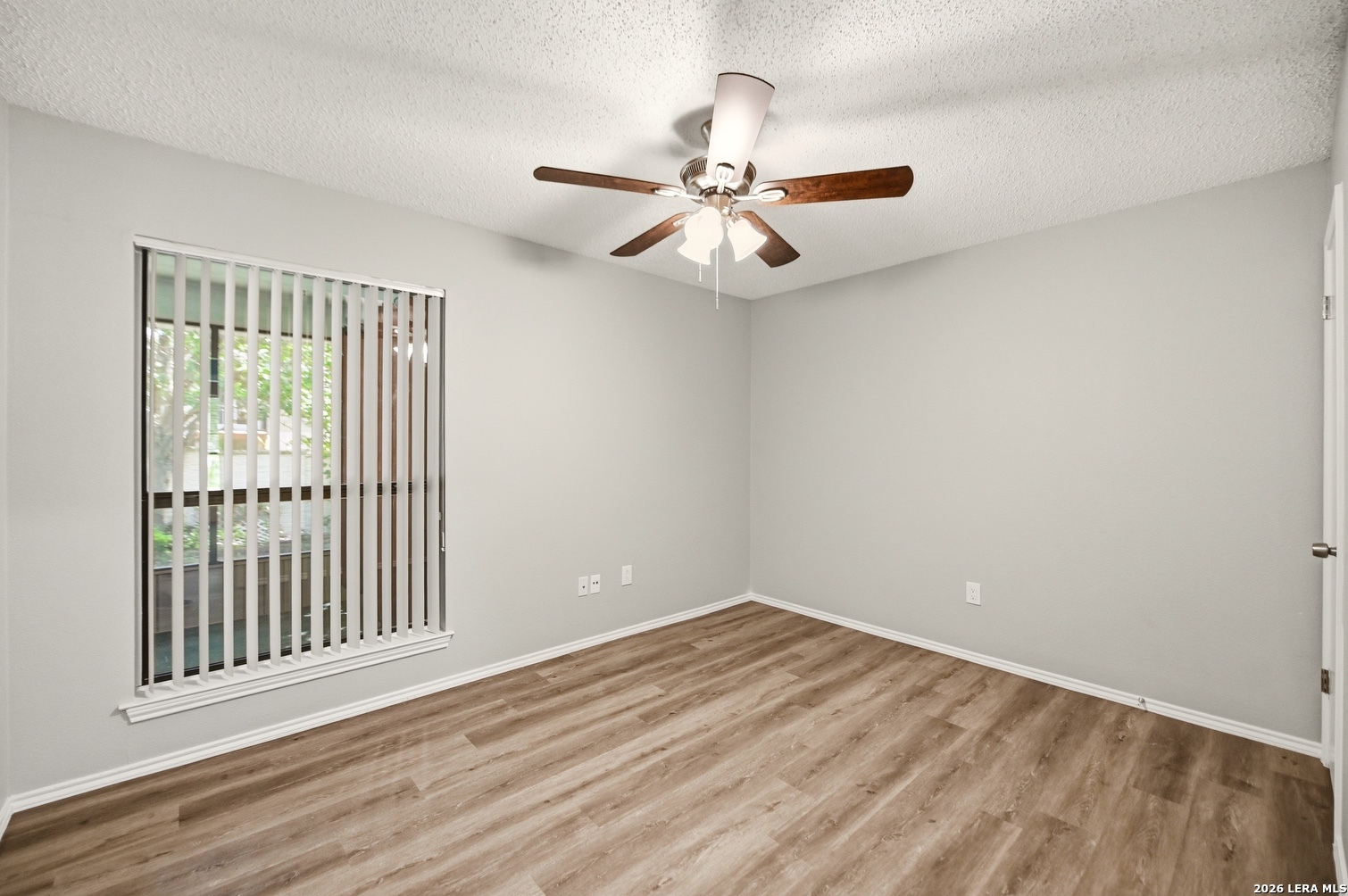 3820 Pheasant Schertz, TX 78108 - Photo 19 of 20 an empty room with wooden floor fan and windows