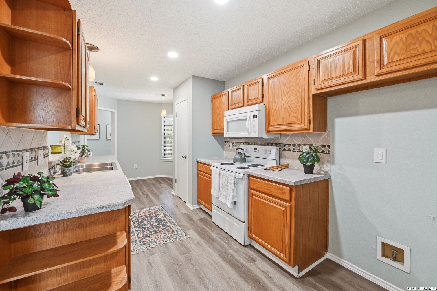 3820 Pheasant Schertz, TX 78108 - Photo 9 of 20 a kitchen with stainless steel appliances granite countertop a stove a sink and a refrigerator