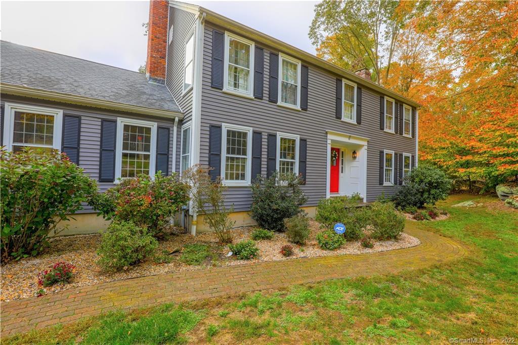 Lovely and gracious Colonial in desirable neighborhood nestles perfectly into its setting