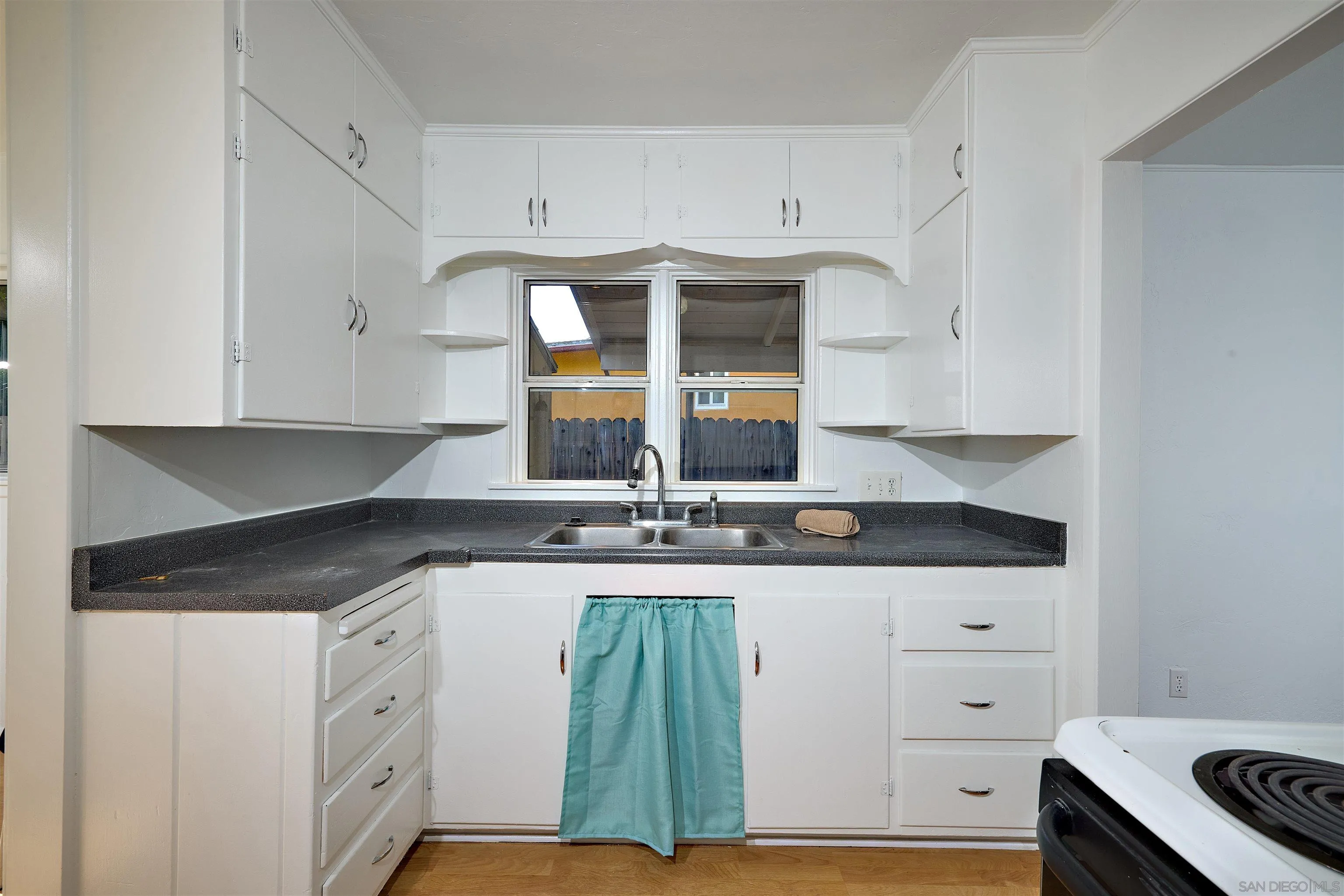 208 Avalon Drive Vista, CA 92084 - Photo 13 of 30 a kitchen with granite countertop a sink and a stove