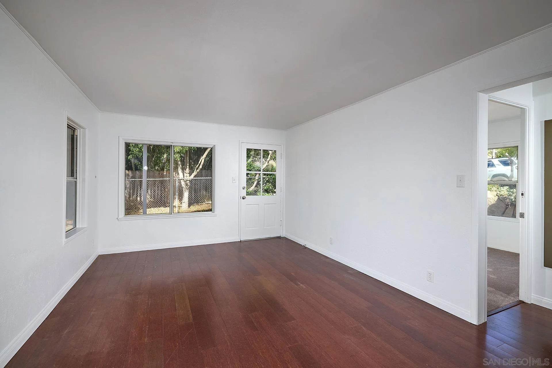 208 Avalon Drive Vista, CA 92084 - Photo 7 of 30 an empty room with wooden floor and windows
