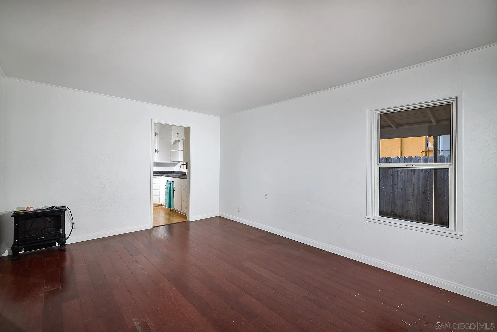 208 Avalon Drive Vista, CA 92084 - Photo 8 of 30 a view of an empty room with wooden floor and a window