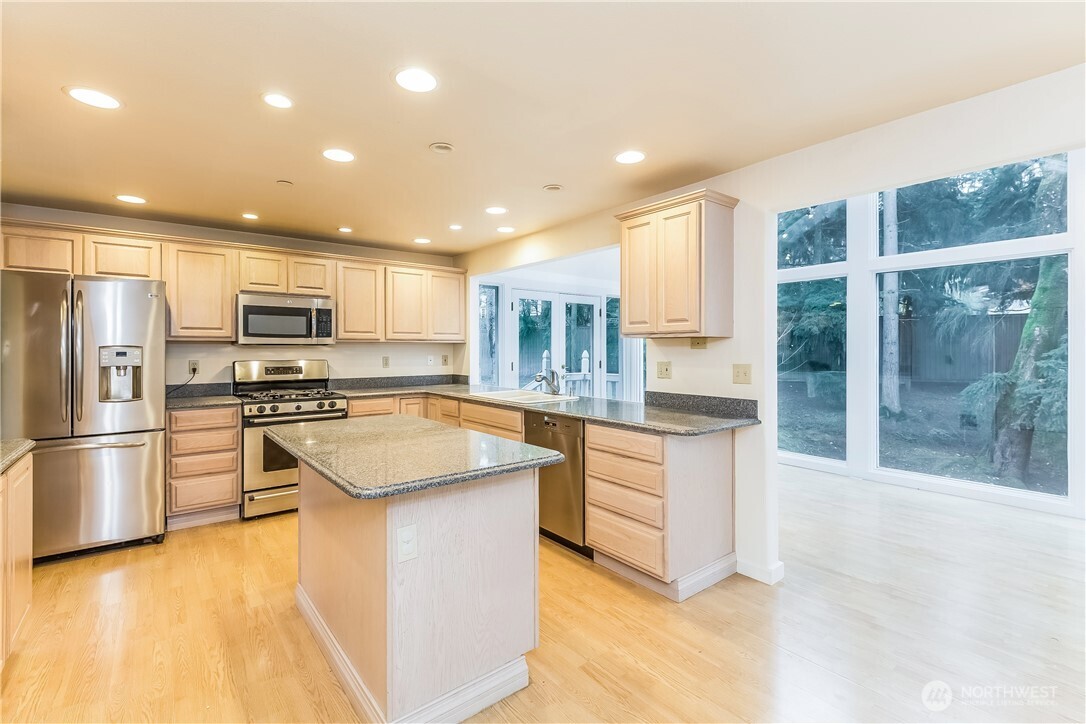 2 Cascade Key Bellevue, WA 98006 - Photo 7 of 24 a kitchen with stainless steel appliances granite countertop a refrigerator a sink a stove and oven