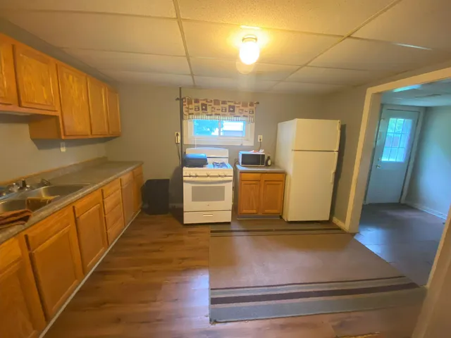 a kitchen with sink a refrigerator and cabinets