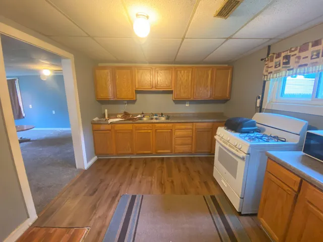 a kitchen with granite countertop a sink and cabinets