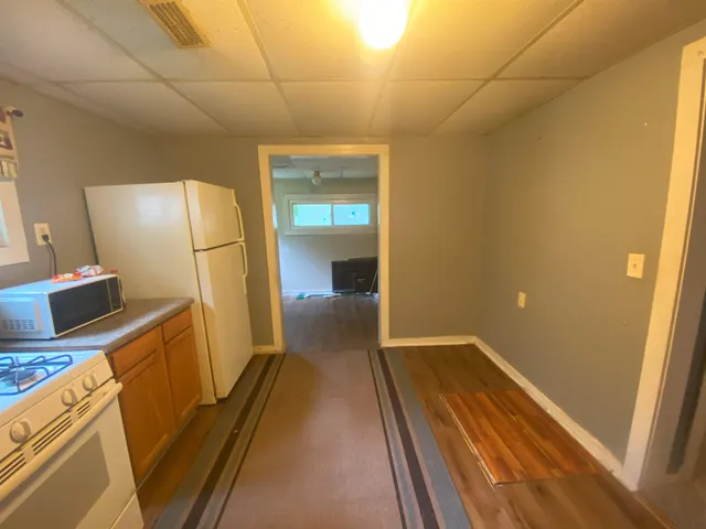 a view of a kitchen from the hallway