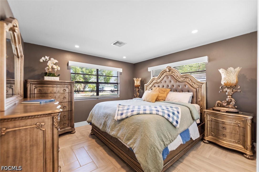 1200 Patterson Road Cape Coral, FL 33909 - Photo 13 of 42 a bedroom with a bed and large windows