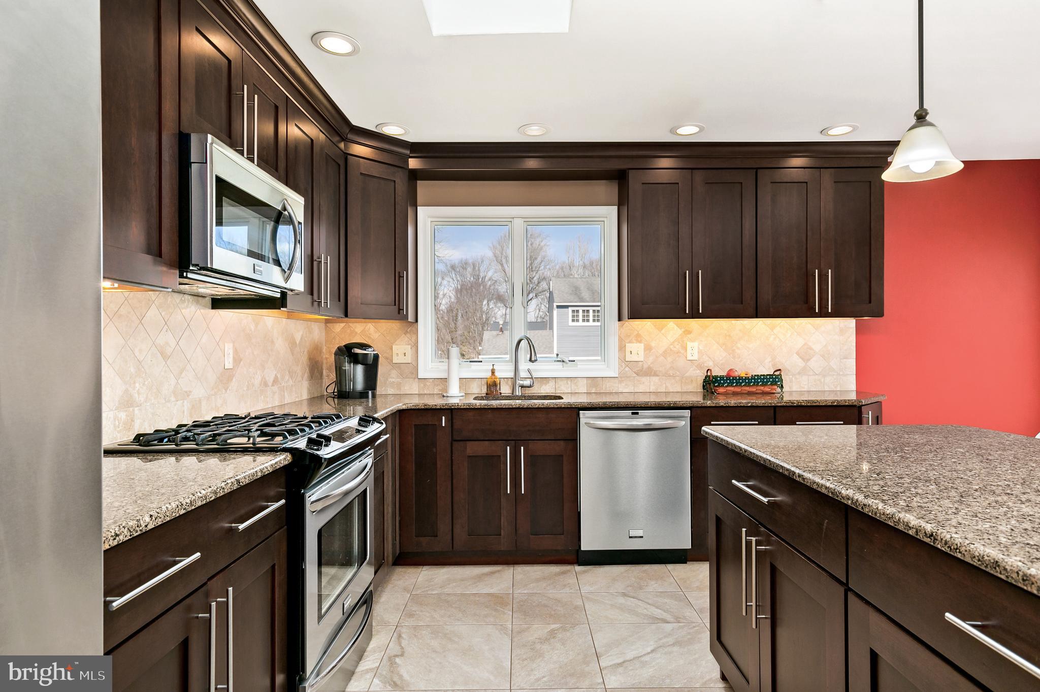 16 Vicksburg Road Laurel Springs, NJ 08021 - Photo 12 of 31 a kitchen with stainless steel appliances granite countertop a stove a sink and a microwave