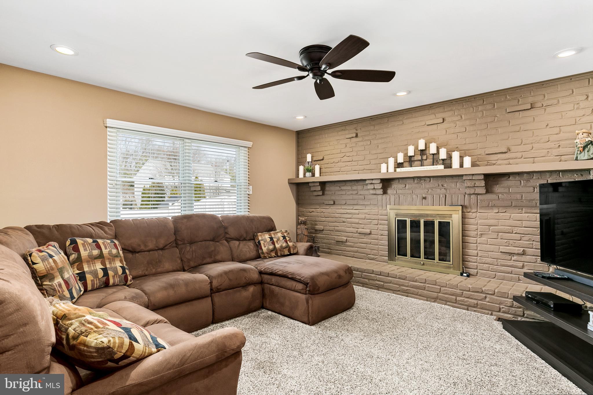 16 Vicksburg Road Laurel Springs, NJ 08021 - Photo 15 of 31 a living room with furniture a fireplace and a flat screen tv