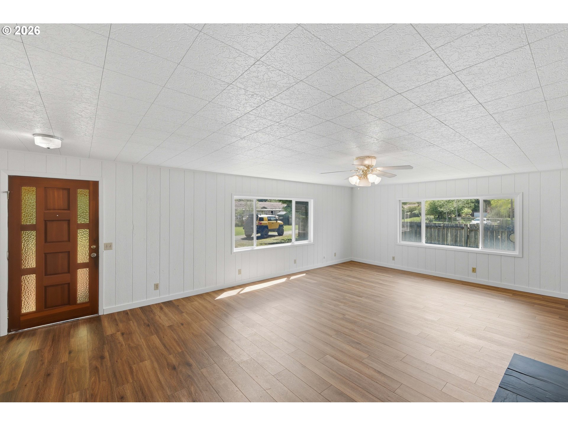 63299 Wildahl Road Coos Bay, OR 97420 - Photo 13 of 45 an empty room with wooden floor and windows