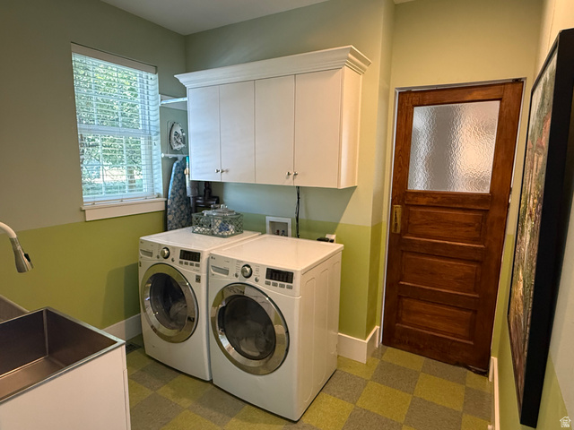 776 Canyon Road Hyde Park, UT 84318 - Photo 16 of 57 Dedicated laundry room featuring checkered flooring, a window with horizontal blinds, overhead white cabinetry, and a utility sink with a pull-down faucet