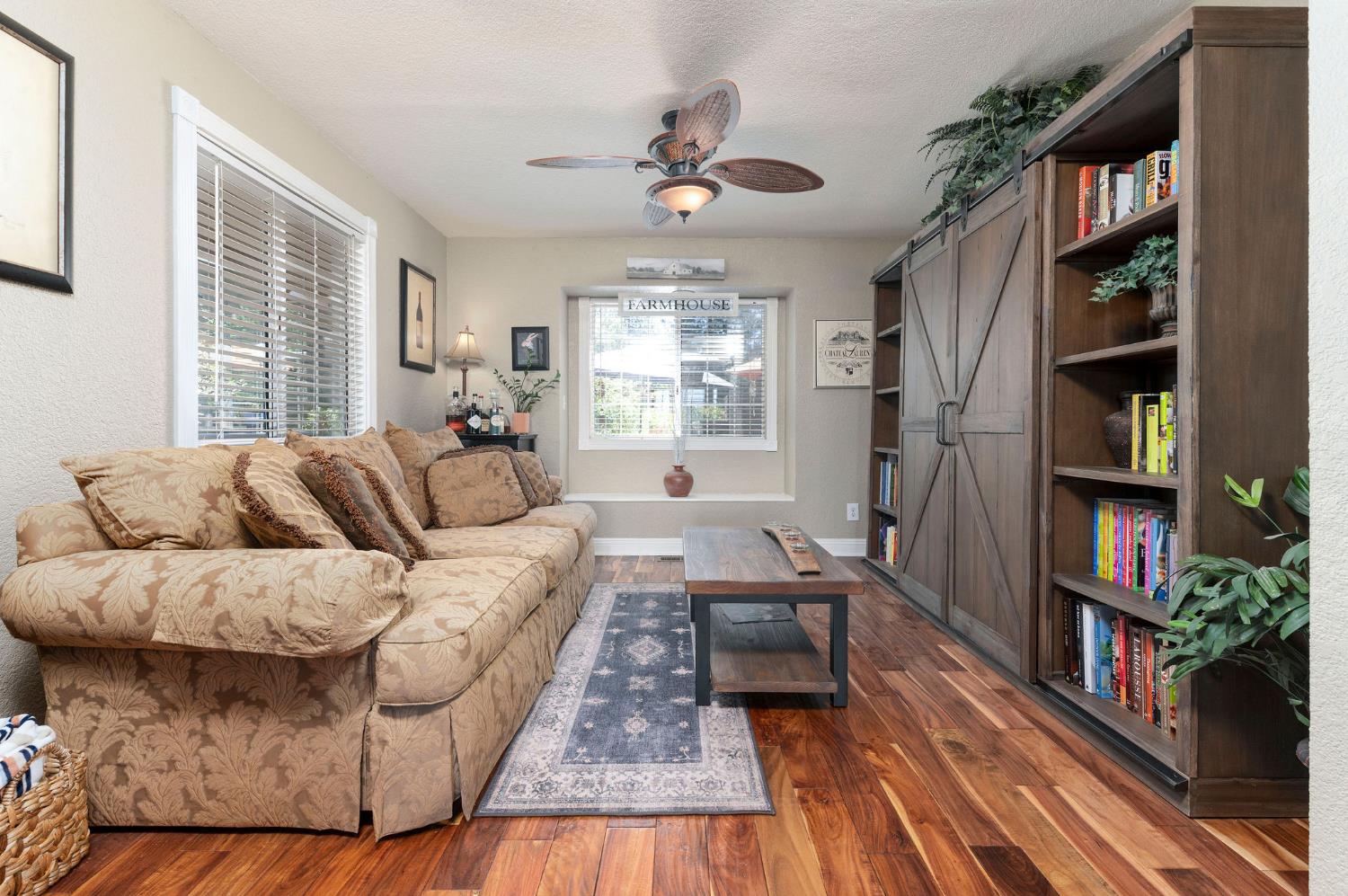 11266 Clinton Bar Road Pine Grove, CA 95665 - Photo 11 of 77 a living room with furniture a rug and a book shelf