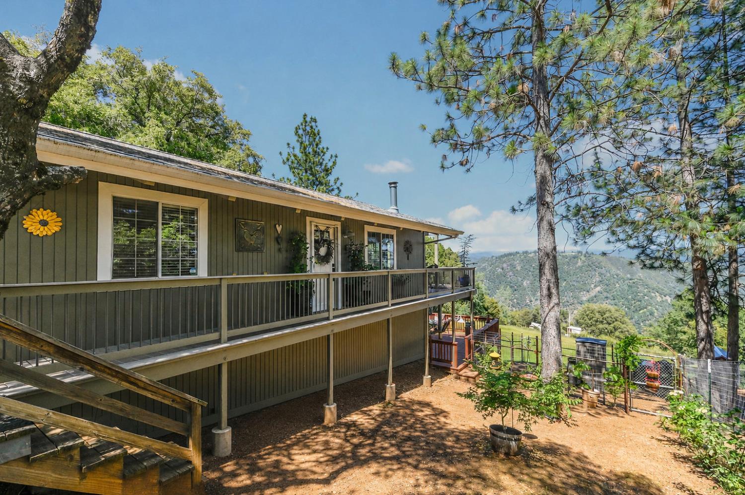 11266 Clinton Bar Road Pine Grove, CA 95665 - Photo 42 of 77 a view of a balcony with chairs and a large tree