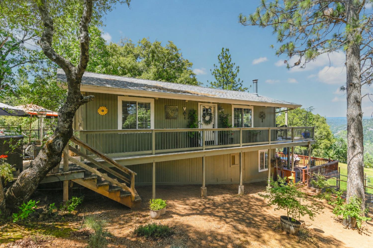 11266 Clinton Bar Road Pine Grove, CA 95665 - Photo 43 of 77 a view of a house with a large window and a yard