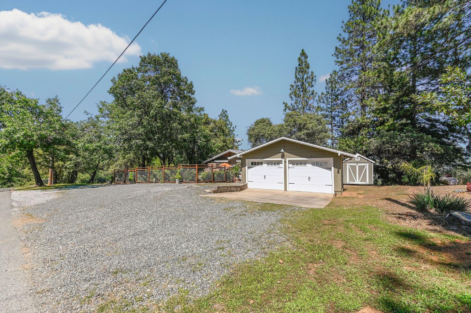 11266 Clinton Bar Road Pine Grove, CA 95665 - Photo 45 of 77 a front view of a house with a yard and garage