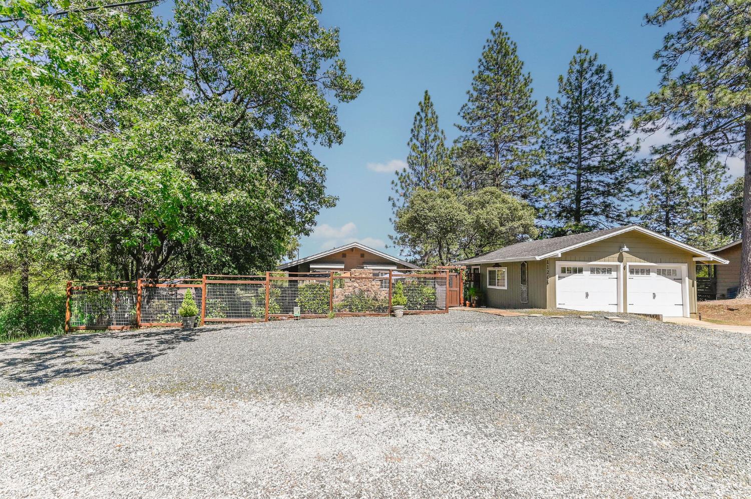 11266 Clinton Bar Road Pine Grove, CA 95665 - Photo 46 of 77 a view of a house with a large tree and a yard