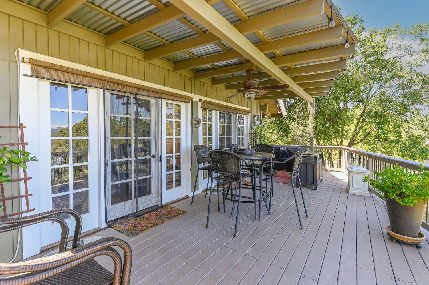 11266 Clinton Bar Road Pine Grove, CA 95665 - Photo 64 of 77 a view of a deck with table and chairs and wooden floor