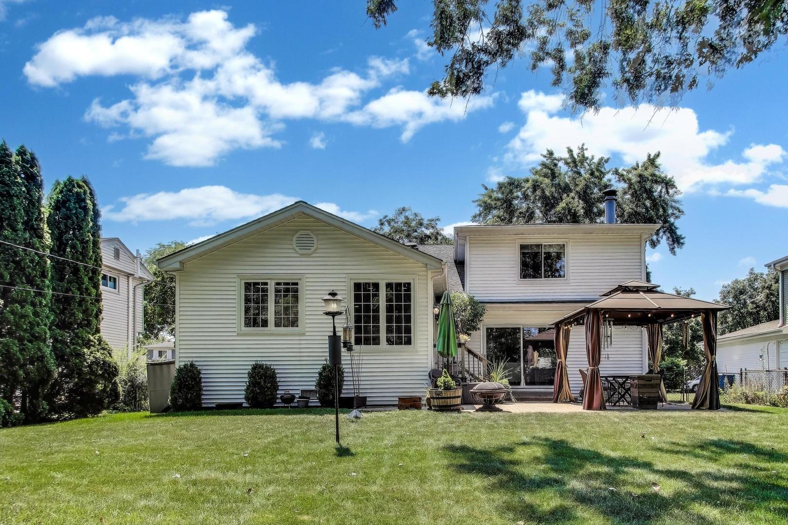 1804 East Apache Lane Mount Prospect, IL 60056 - Photo 19 of 27 a front view of a house with a yard