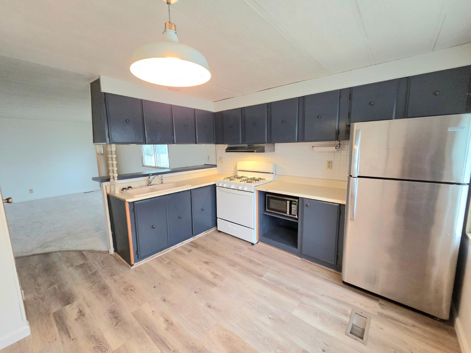 5200 Cavitt Stallman Road, Unit 18 Granite Bay, CA 95746 - Photo 13 of 20 a kitchen with stainless steel appliances a refrigerator sink and cabinets