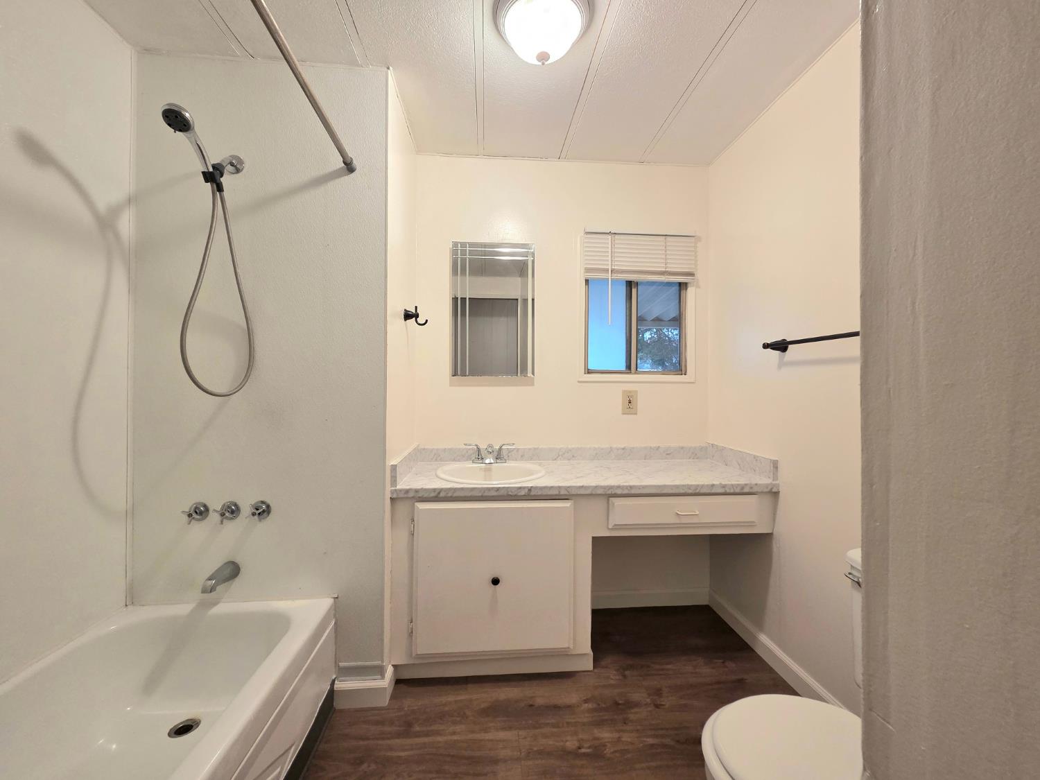 5200 Cavitt Stallman Road, Unit 18 Granite Bay, CA 95746 - Photo 9 of 20 a bathroom with a tub sink and mirror