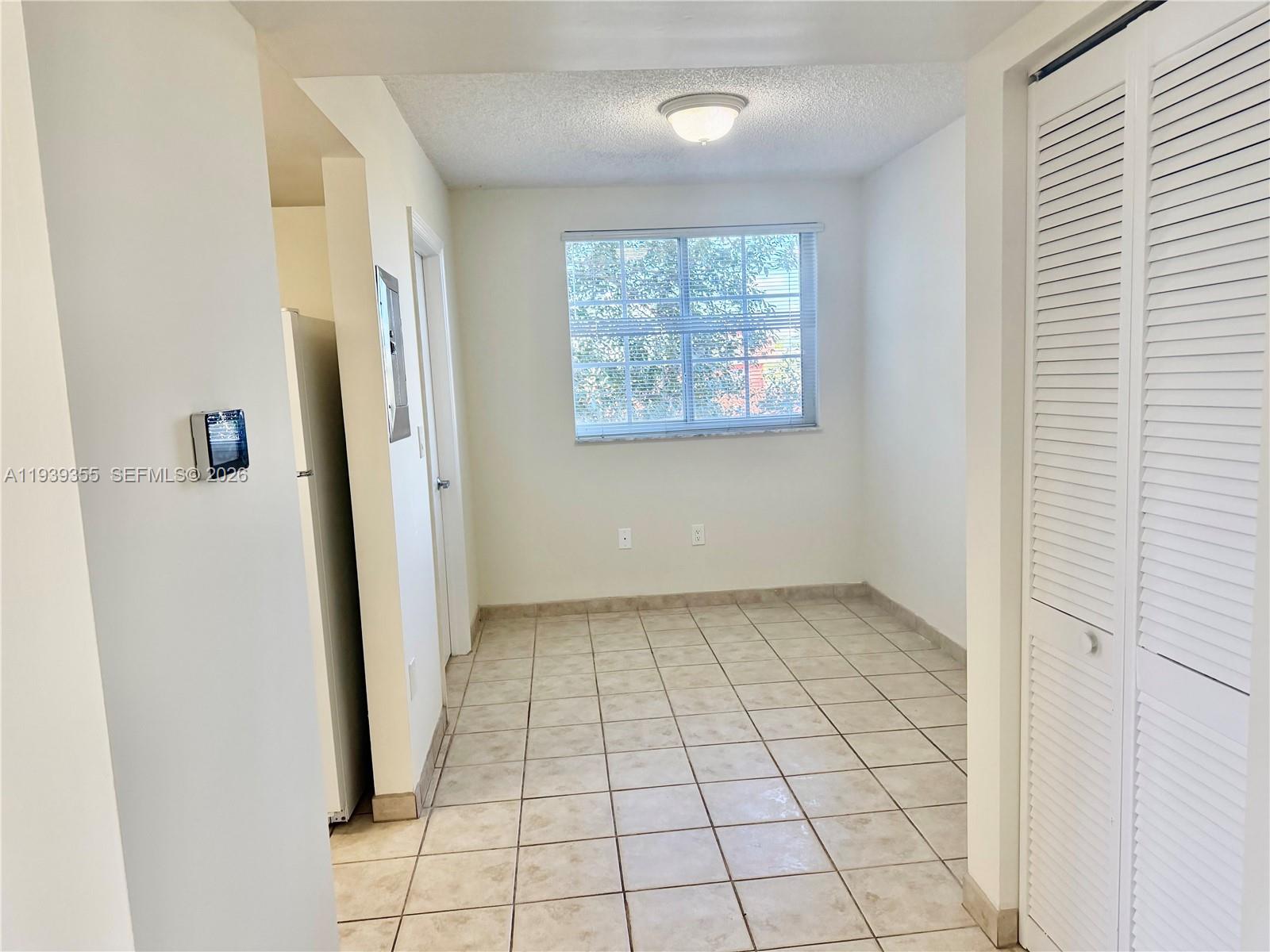 601 Southwest 37th Avenue, Unit 301 Miami, FL 33135 - Photo 13 of 22 an empty room with windows