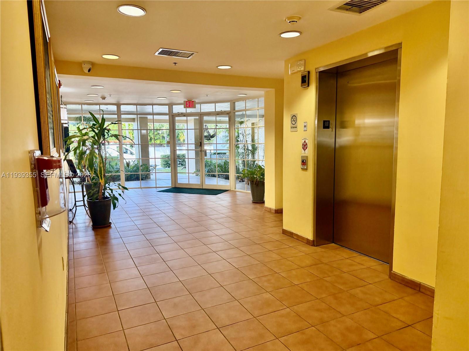 601 Southwest 37th Avenue, Unit 301 Miami, FL 33135 - Photo 19 of 22 a lobby with furniture and floor to ceiling window