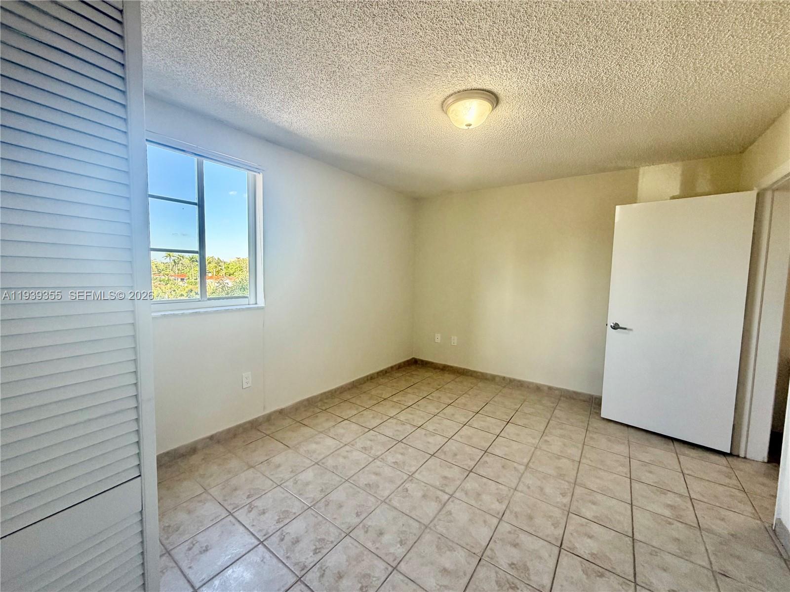 601 Southwest 37th Avenue, Unit 301 Miami, FL 33135 - Photo 6 of 22 a view of an empty room and window