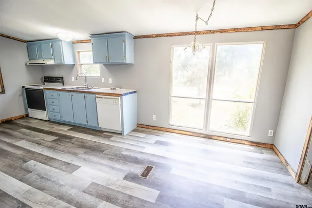 a kitchen with a window cabinets and a sink