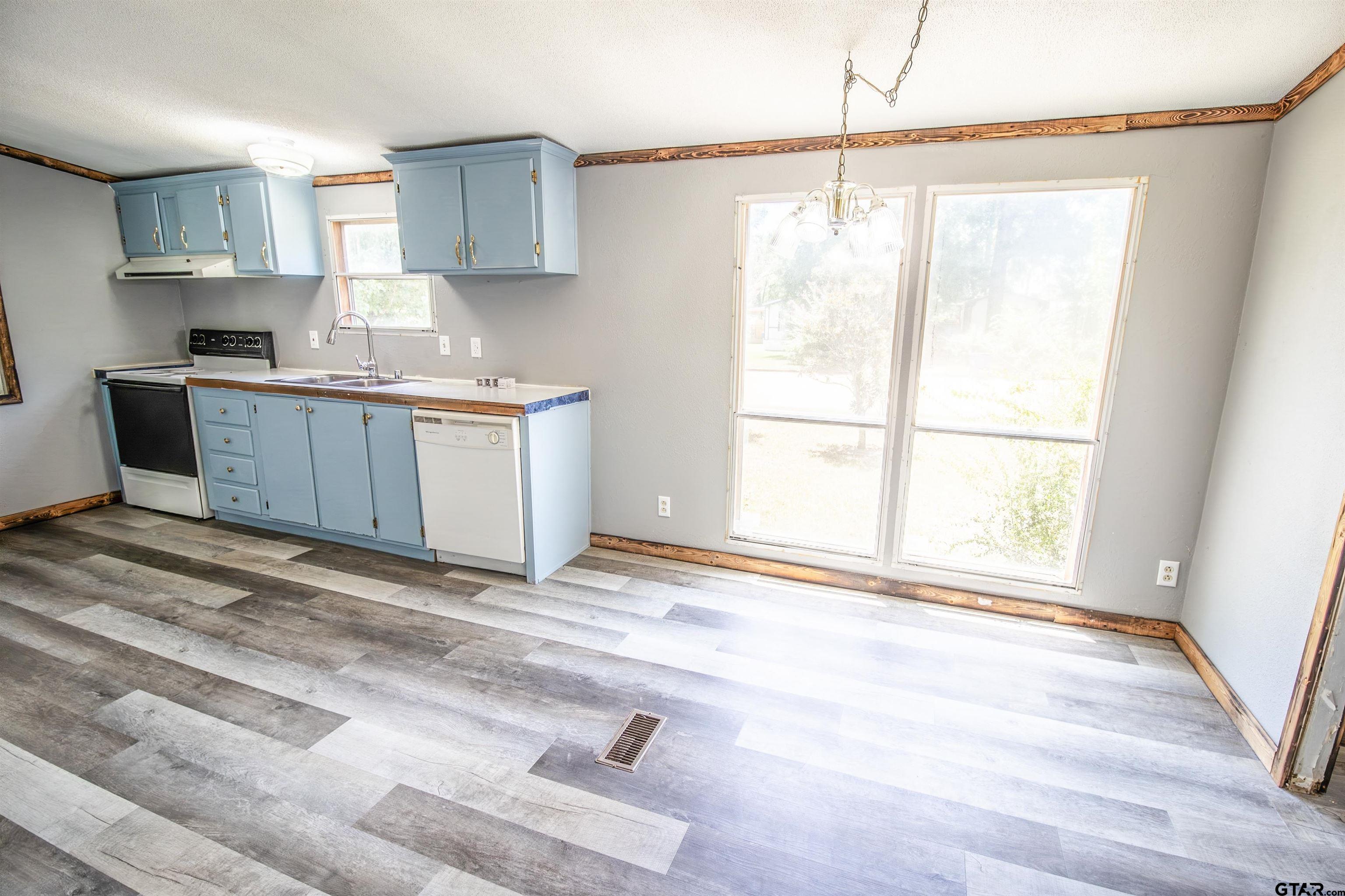 12450 Fannin Parkway Tyler, TX 75708 - Photo 12 of 39 a kitchen with a window cabinets and a sink