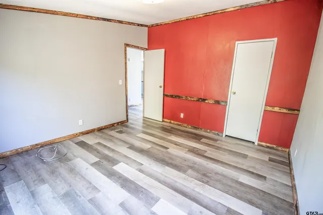 a view of a room with wooden floor and bathroom