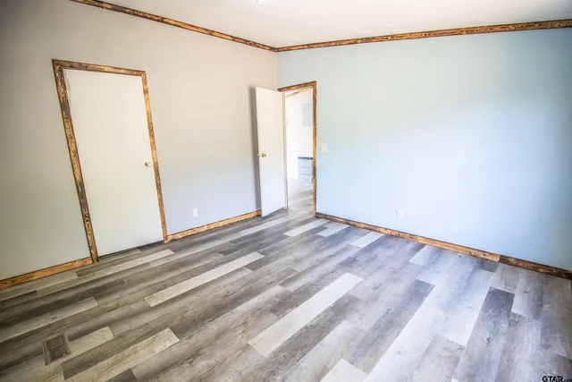 a view of a room with wooden floor