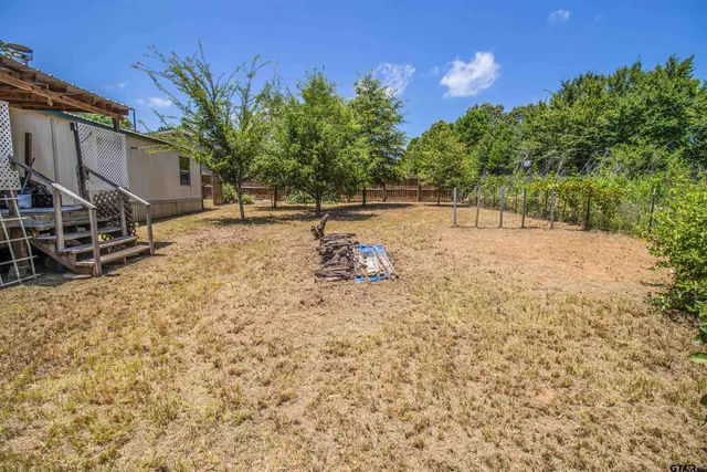 a backyard of a house with lots of green space