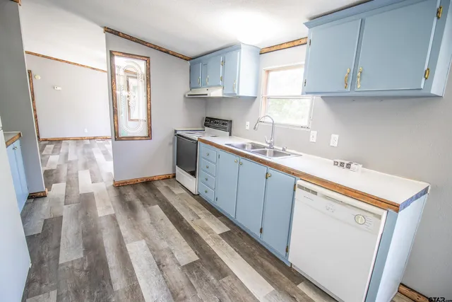 a kitchen with a sink window and cabinets