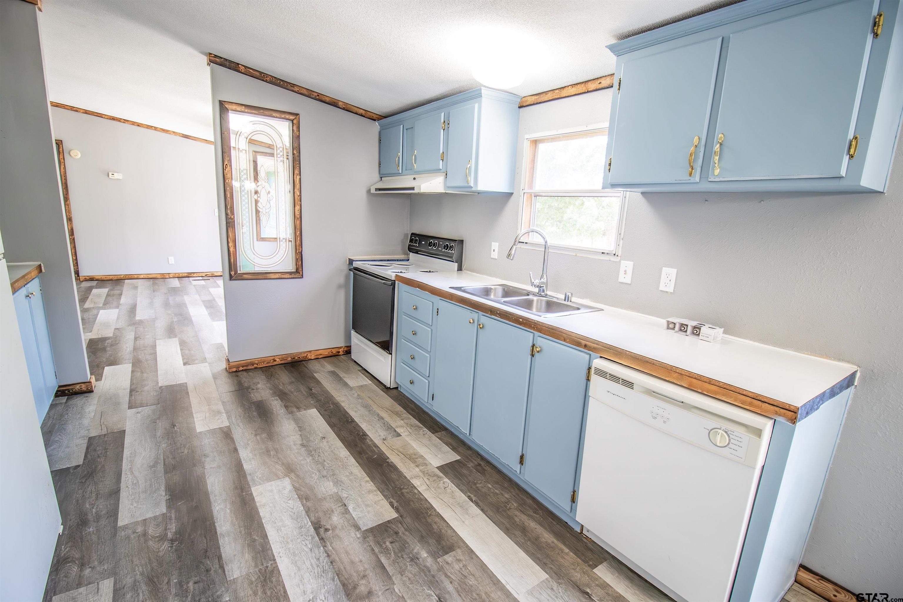12450 Fannin Parkway Tyler, TX 75708 - Photo 10 of 39 a kitchen with a sink window and cabinets