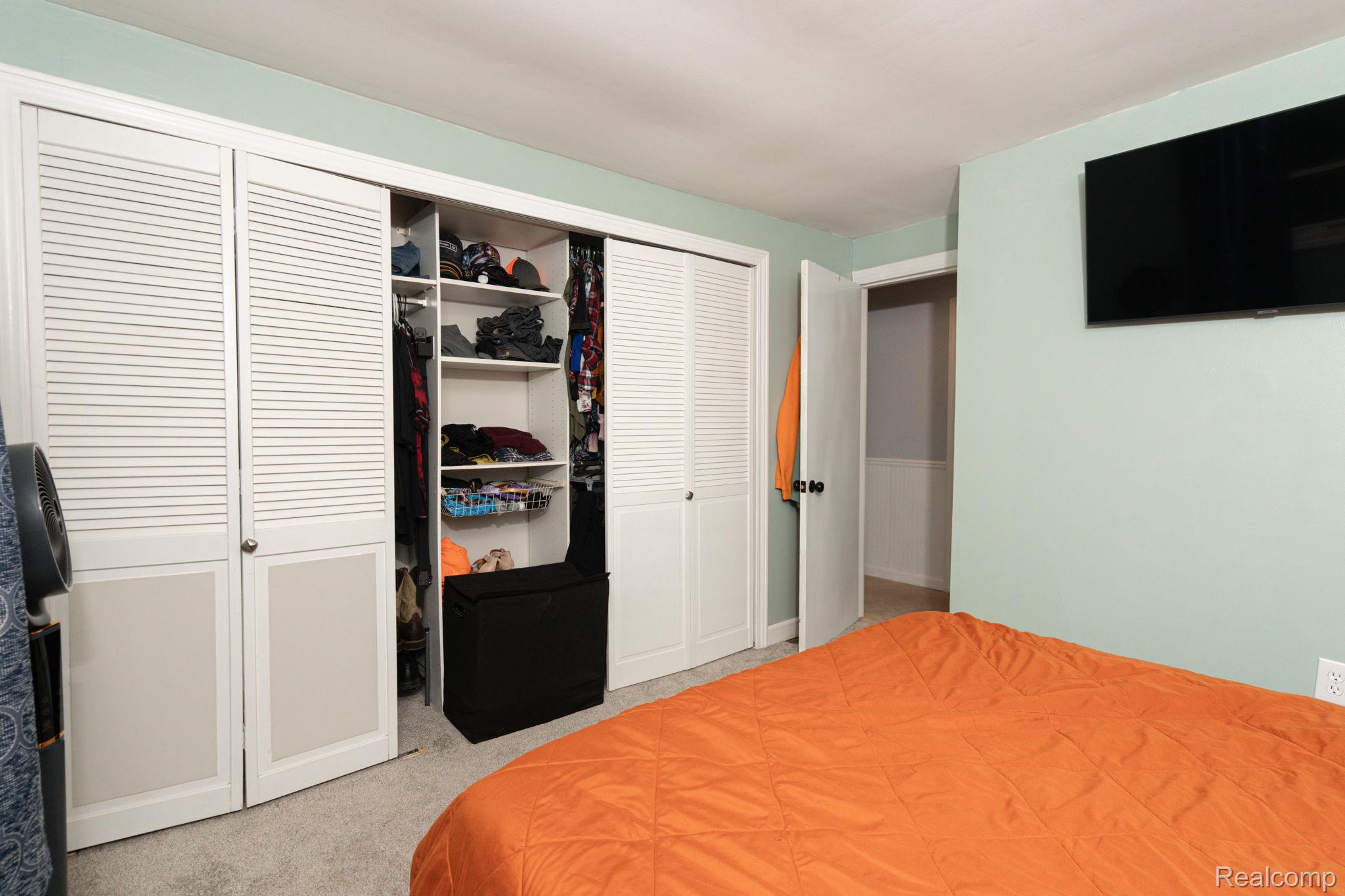1775 Porter Road White Lake, MI 48383 - Photo 31 of 33 Built-in closet with louvered bi-fold doors and interior shelving