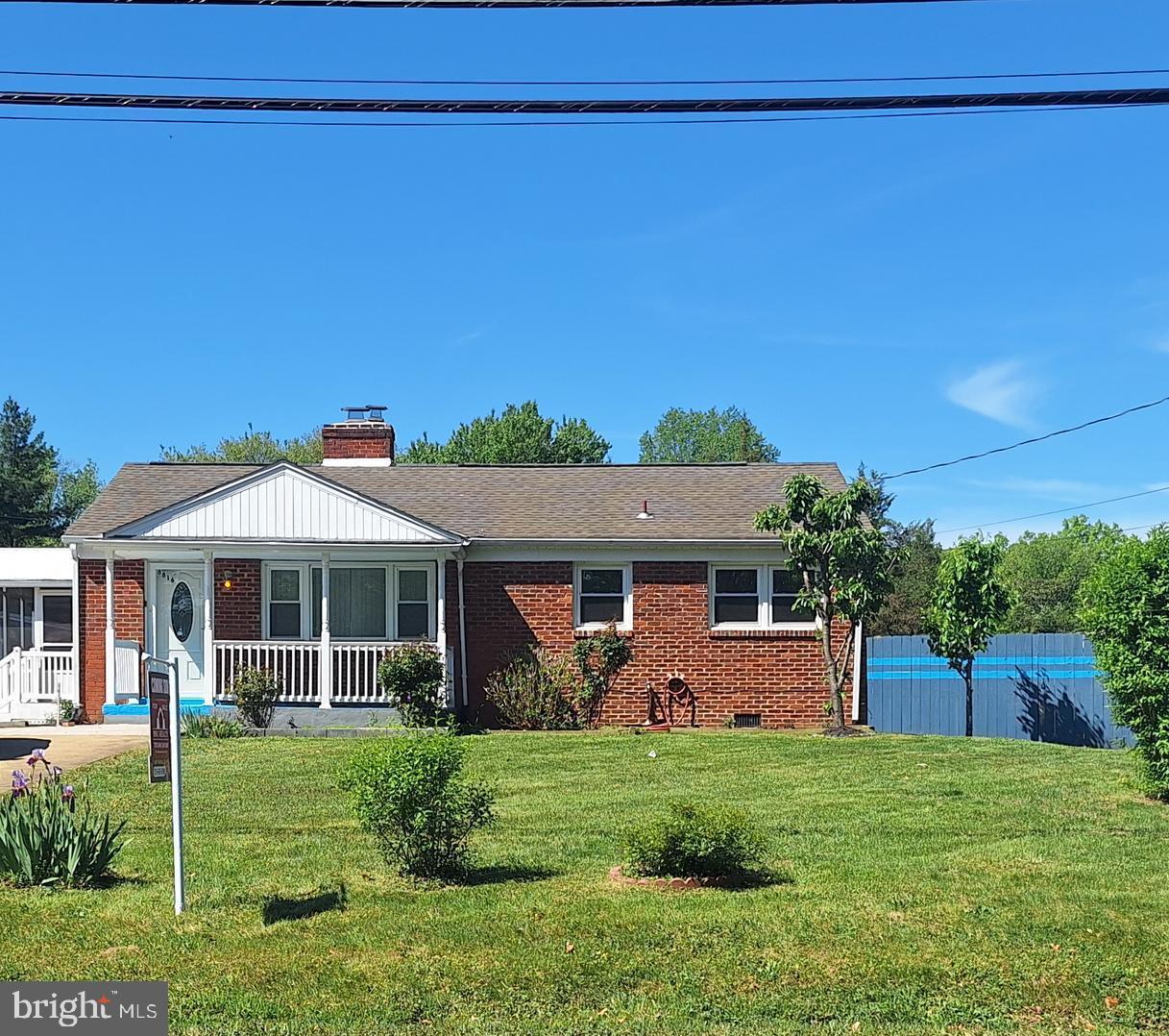 8816 Cooper Road Alexandria, VA 22309 - Photo 1 of 52 a front view of a house with a yard
