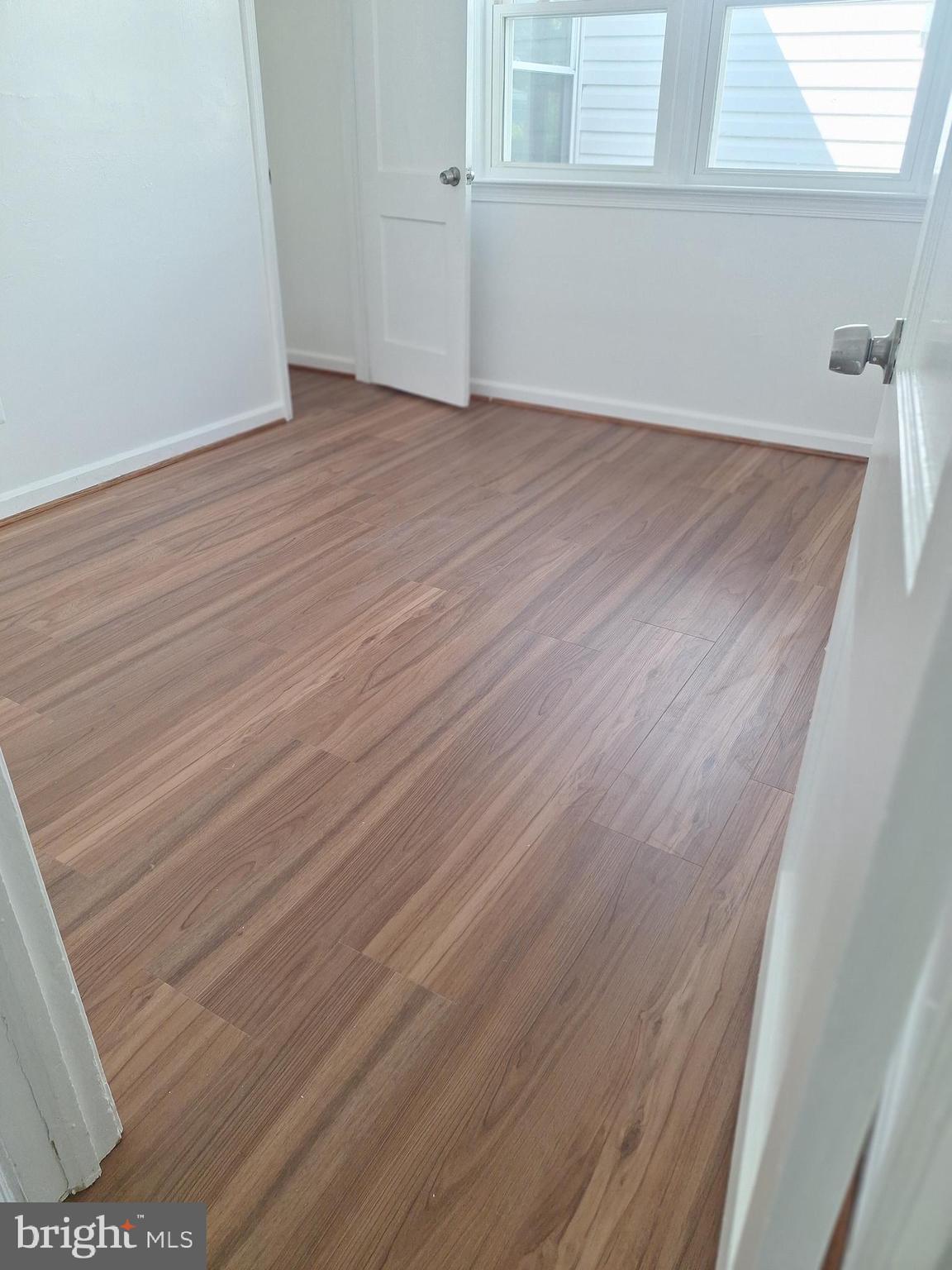 8816 Cooper Road Alexandria, VA 22309 - Photo 21 of 52 a view of an empty room with wooden floor and a window