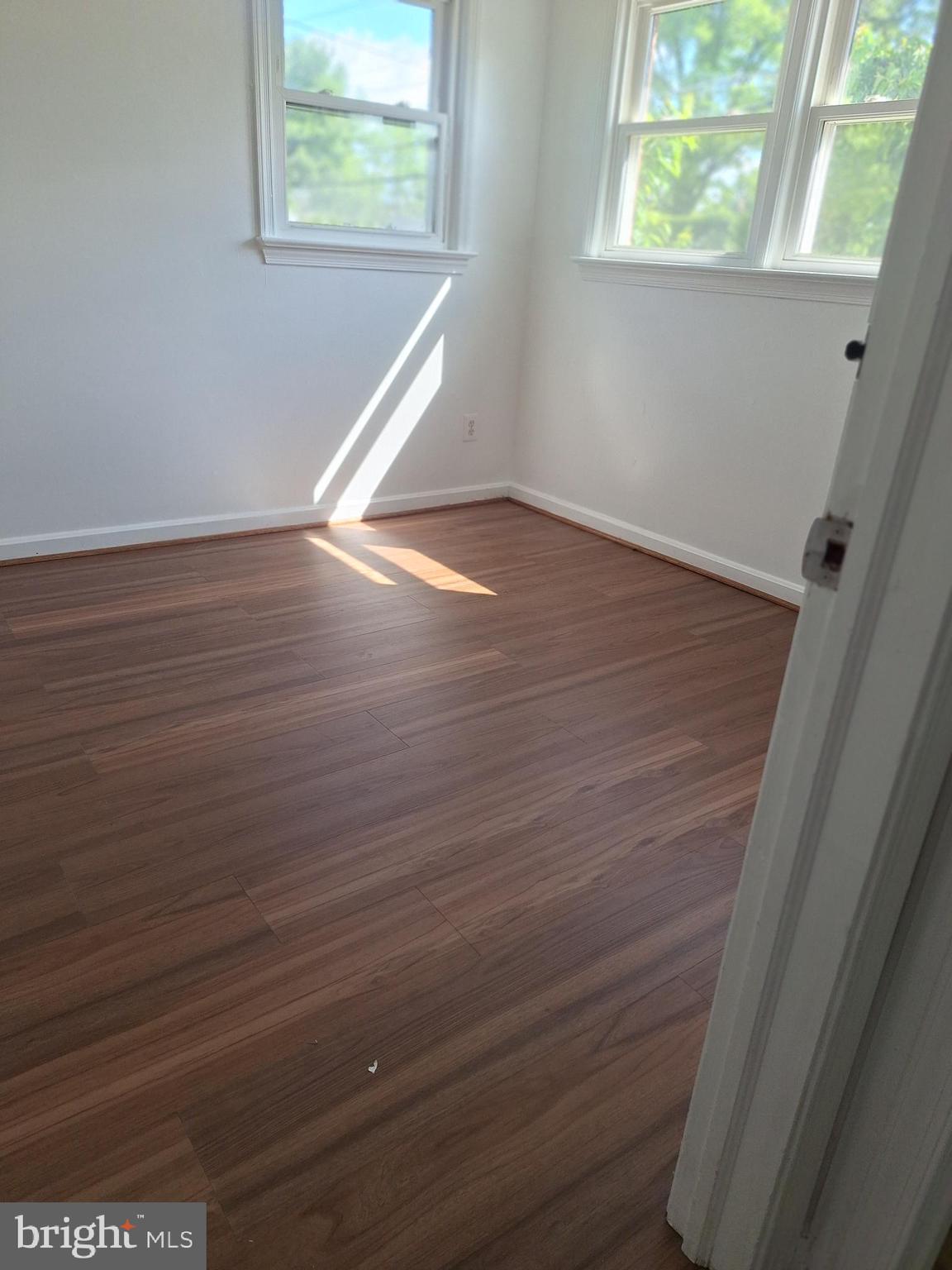 8816 Cooper Road Alexandria, VA 22309 - Photo 24 of 52 an empty room with wooden floor and windows