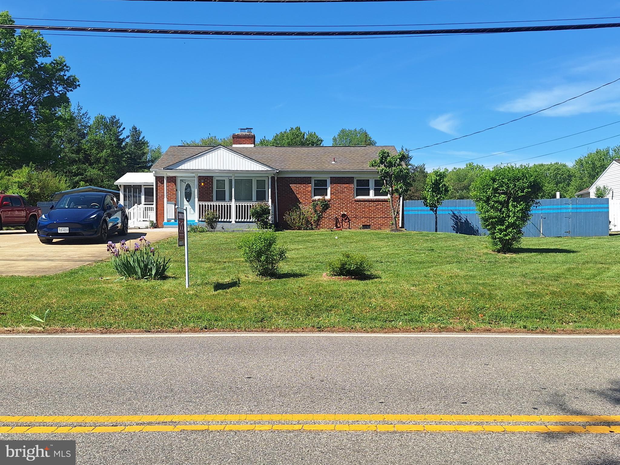 8816 Cooper Road Alexandria, VA 22309 - Photo 30 of 52 a front view of a house with a yard and potted plants